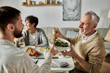 A gay couple shares a meal with parents at home.