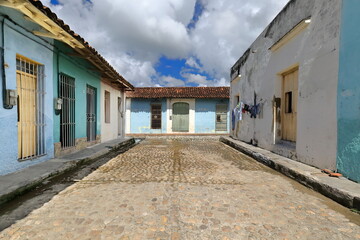 Cobbled Calle Hernan Lopez Street going northwest until the transversal, southwest-northeast lined Calle Manuel Diaz Street. Sancti Spiritus-Cuba-341