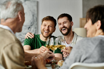 A gay couple toasts with parents during a celebratory dinner at home.
