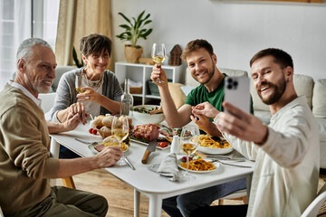 A gay couple and parents share a meal and smiles at home.