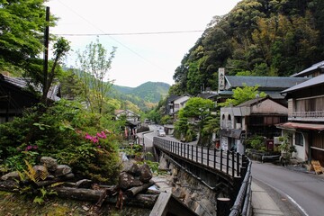 Fototapeta premium A view of the Yunomine Onsen, a hot spring system and resort town in Tanabe, near Hongu Town in southern Wakayama Prefecture, Japan. The Tsuboyu bath is located there, a UNESCO World Heritage site