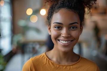 Fototapeta premium Happy woman with curly hair in yellow shirt at diner