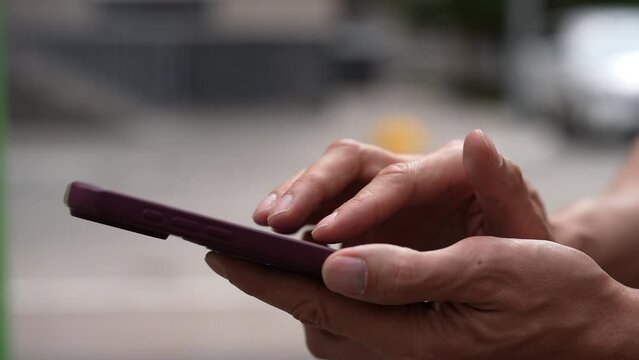 Man quickly tapping fingers on smartphone screen to farming new popular Hamster Combat cryptocurrency in mobile phone online application. Male extract crypto coins using smartphone, slow motion.