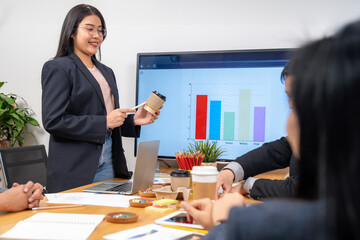 A young woman is presenting a prototype of a product at a conference