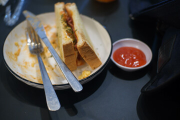 egg sandwich with margarine and vegetables on a ceramic plate