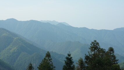 The beautiful mountains landscapes with the green forest and the erupted rock cliff as background in the countryside of the China