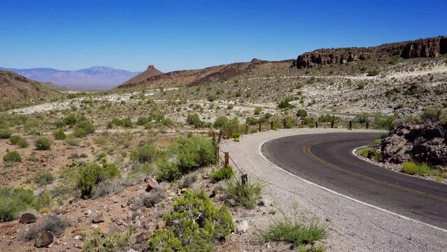 Pan left of the Black Mountains and a winding section of historic Route 66 near Oatman in Mohave County, Arizona. 4K UHD video.