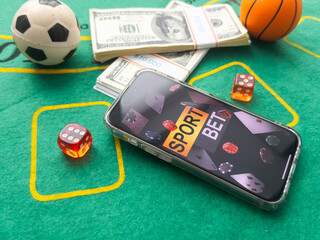 Online poker concept. Smartphone and poker chips on a green background. Poker online banner. Copy space. Vignette. Place for text. Gambling. Background