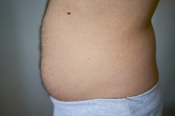 the side and stomach of a thirty-year-old man of average build