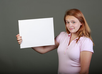 Young teenager in the studio with a blank sign