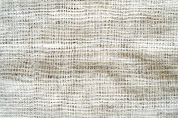 Close-up of burlap fabric texture with a natural, rough appearance, showcasing intricate weaving patterns and neutral color tones.