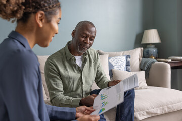 Senior male meeting with a financial advisor in his home
