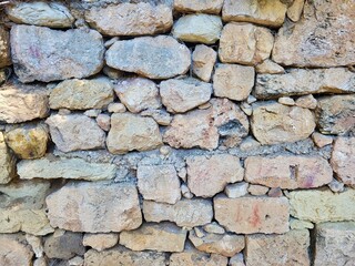 The art wall. Stones wall fragment of classic alpen mountain house. Ancient architecture, handmade. Adriatica landscape on sunset. Creative vintage natural brown background. Toned image. Brick wall