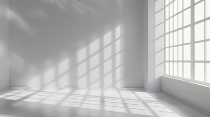 Bright, sunlit empty white room with large grid windows casting shadows. Minimalist interior design featuring clean lines and abundant natural light.
