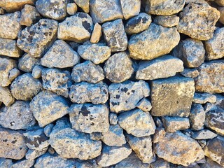 Natural stone slice texture background. Stone wall background texture - vintage. Colorful pebbles stones texture background. Home and office design backdrop. Wall of an old stone laying