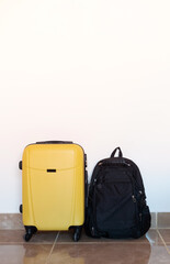 yellow suitcase on white wall background in hotel room