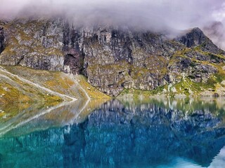 It is a famous sightseeing spot where rocky walls continue along the river. Highline in the mountains. Man catches balance. Autumn landscape aerial view. Mountain lake in the autumn season