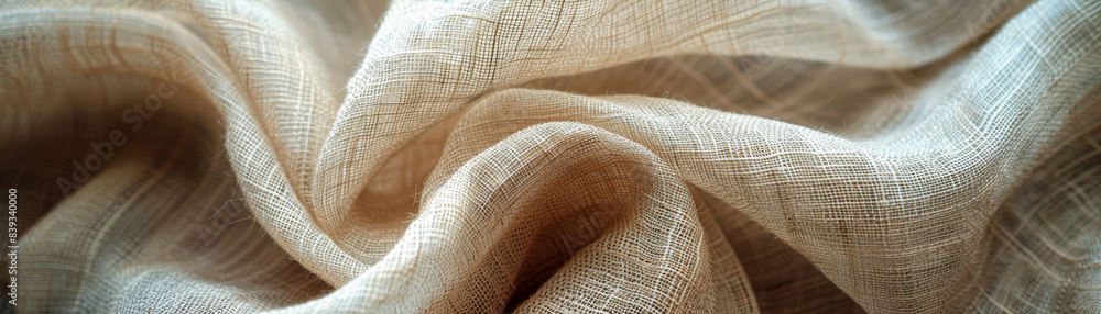 Poster close-up of beige fabric with a detailed woven texture, showcasing intricate patterns and soft folds