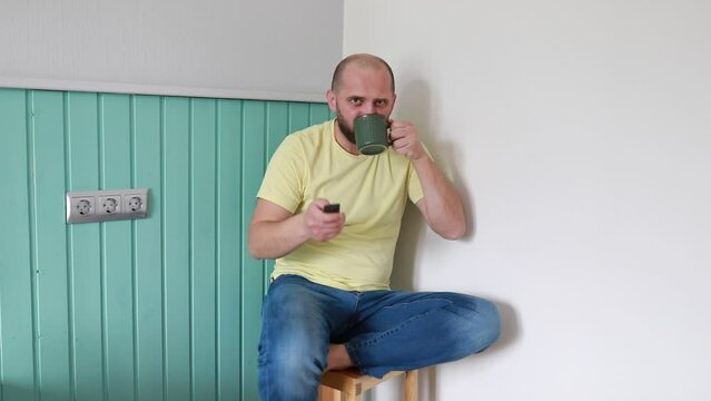 Man in Yellow Shirt Engaging in Indoor Wall Painting During Daytime Renovation Project