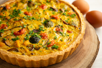 French quiche with fall vegetables such as brussels sprouts, sweet potato, and mushrooms.