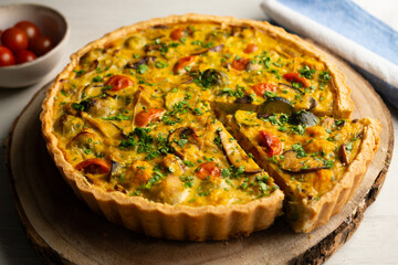 French quiche with fall vegetables such as brussels sprouts, sweet potato, and mushrooms.