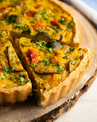 French quiche with fall vegetables such as brussels sprouts, sweet potato, and mushrooms.