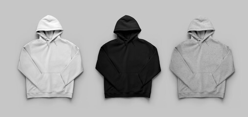 Mockup of white, black, heather oversized hoodie laid out, isolated on background, front view, set.