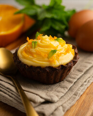 Chocolate tartlets with orange cream.