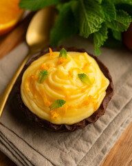 Chocolate tartlets with orange cream.