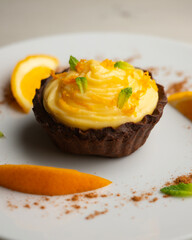 Chocolate tartlets with orange cream.