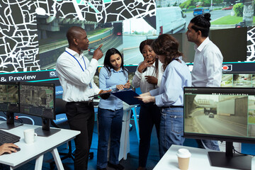 Diverse group of operators discussing ways to improve express shipping and delivery, tracking...