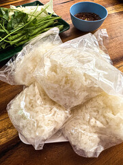 Steamed sticky rice in plastic carry bags. Close up