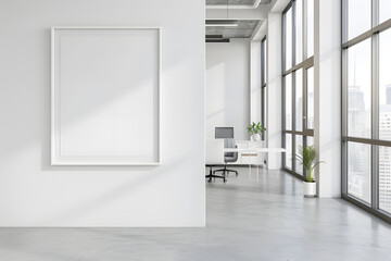 A clean, white frame on a minimalist office desk, with sleek furniture and large windows allowing natural light to fill the space