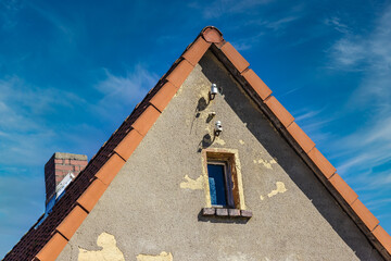Detail of a house gable with vintage electrical connections