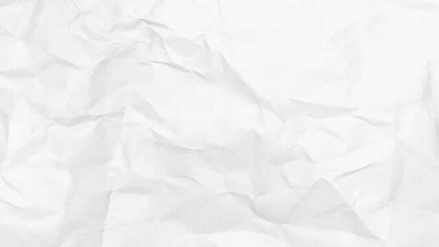 Close-up of a wrinkled white sheet of paper. The wrinkled surface is characterized by sharp creases and soft folds.