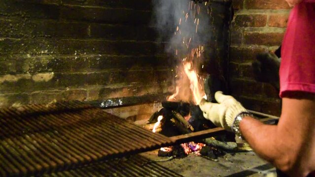 Man cooking meat on a barbecue a summer night