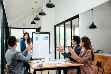Naklejka premium Group of teamwork businesspeople are clapping hands to success and archive on business financial and marketing after working on laptop and paperwork sit on sofa in commonual room