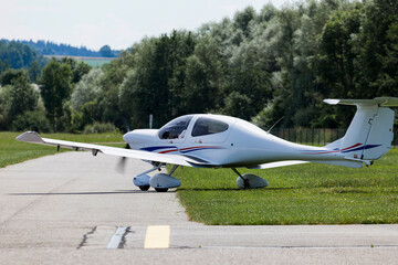 small propeller aircraft rolling to the runway for takeoff at a rural airport  © Reischi