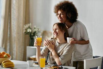 A happy lesbian couple enjoying breakfast together at home.