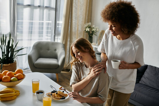 A lesbian couple enjoys a cozy breakfast together at home.