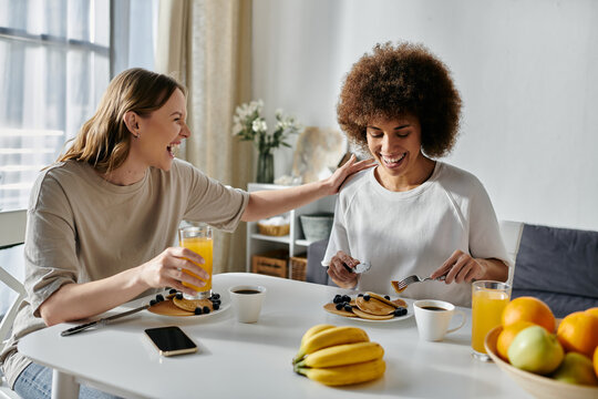 Two women enjoy a cozy breakfast at home.