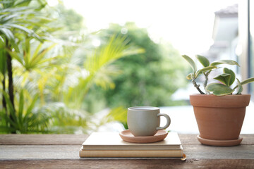 tea cup and notebook and plant pot at balcony outdoor