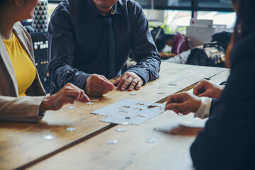 Strategy Planning and Solution Business Concept. Group of Business people holding piece of jigsaw...