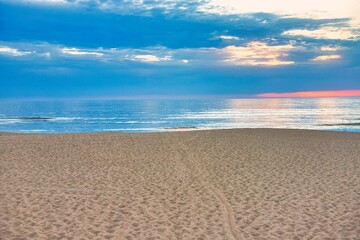 Soft sand and blue sky. The sea and the beach under the blue sky and white clouds. Sea sand sky and summer day. Inspirational nature landscape, beautiful colors, wonderful scenery of tropical beach