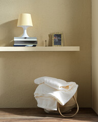 laundry basket with towels in a living space on a bright background with props