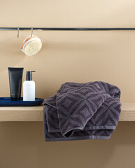 grey towels on the bathroom shelf
