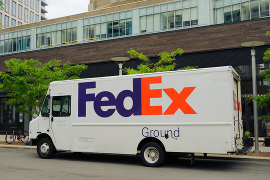 Cambridge, USA - 29 May 2024. FedEx Ground Shipping delivery vehicle parked on a street at Kendall square