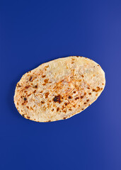 Traditional Eastern Bread with Bean Filling on Blue Background — Authentic Baked Goods Photography