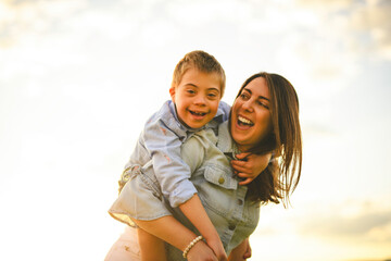 Nice mother and child Playing on great field at Sunset