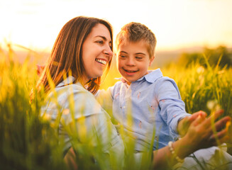 Nice mother and child Playing on great field at Sunset